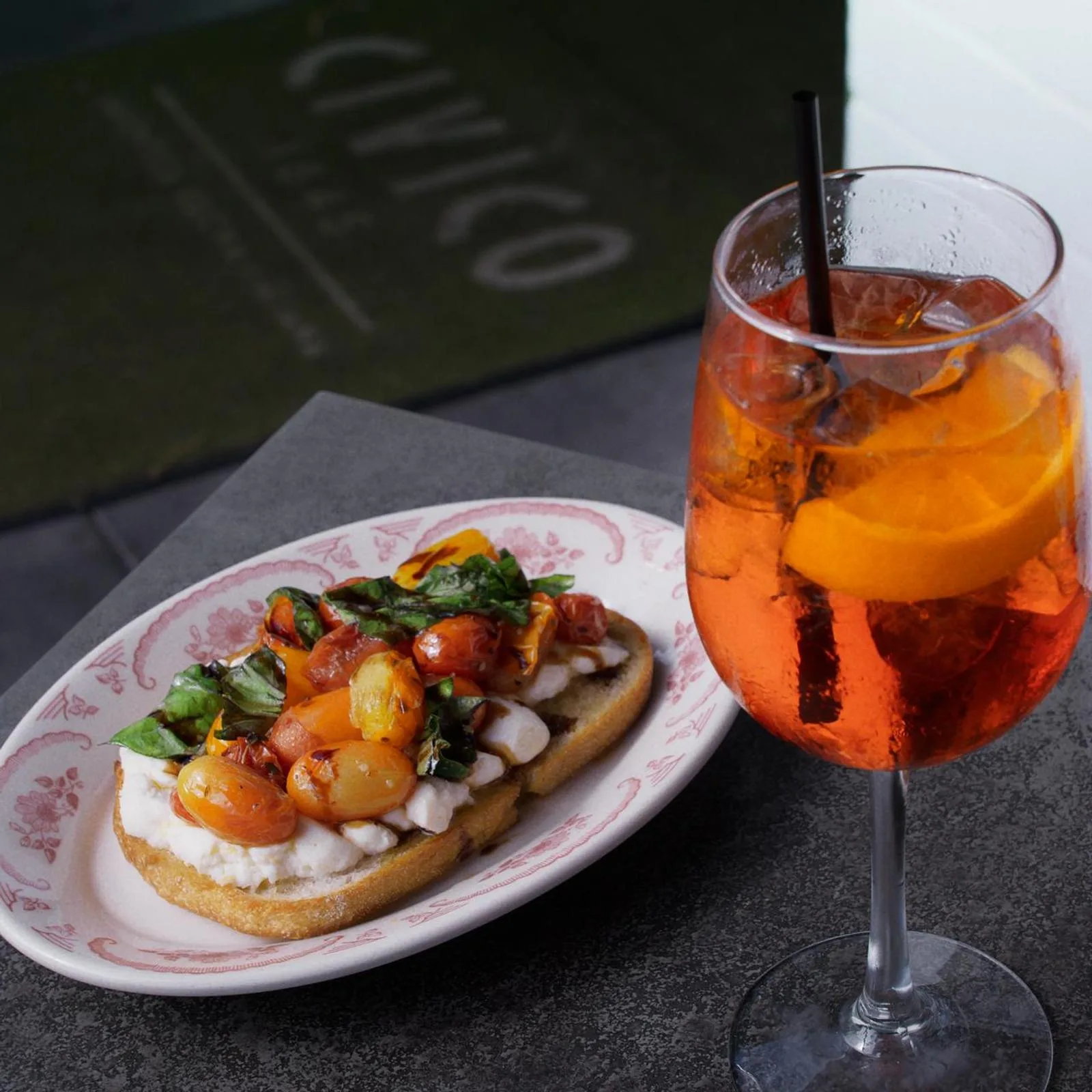 Aperol spritzes and shared plates arranged on a Civico 1845 table