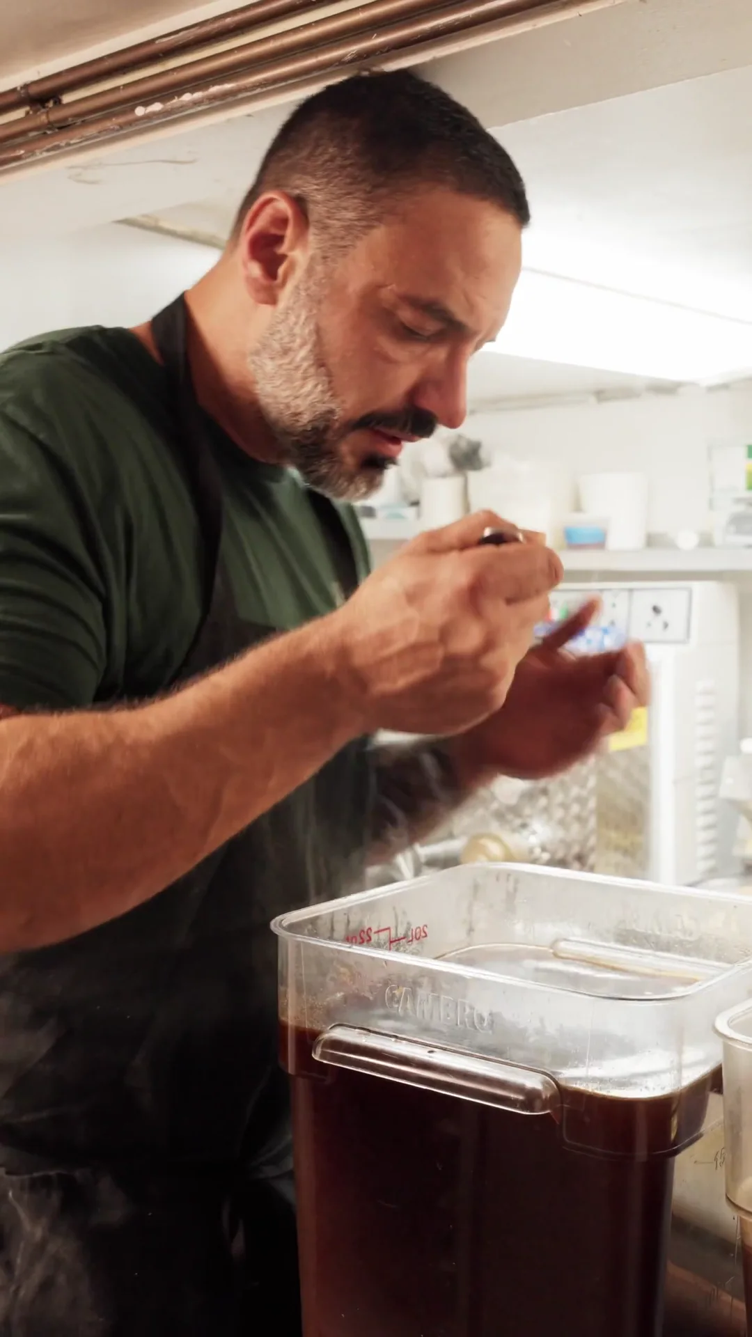 Chef Pietro Gallo tasting a preparation in the Civico 1845 kitchen