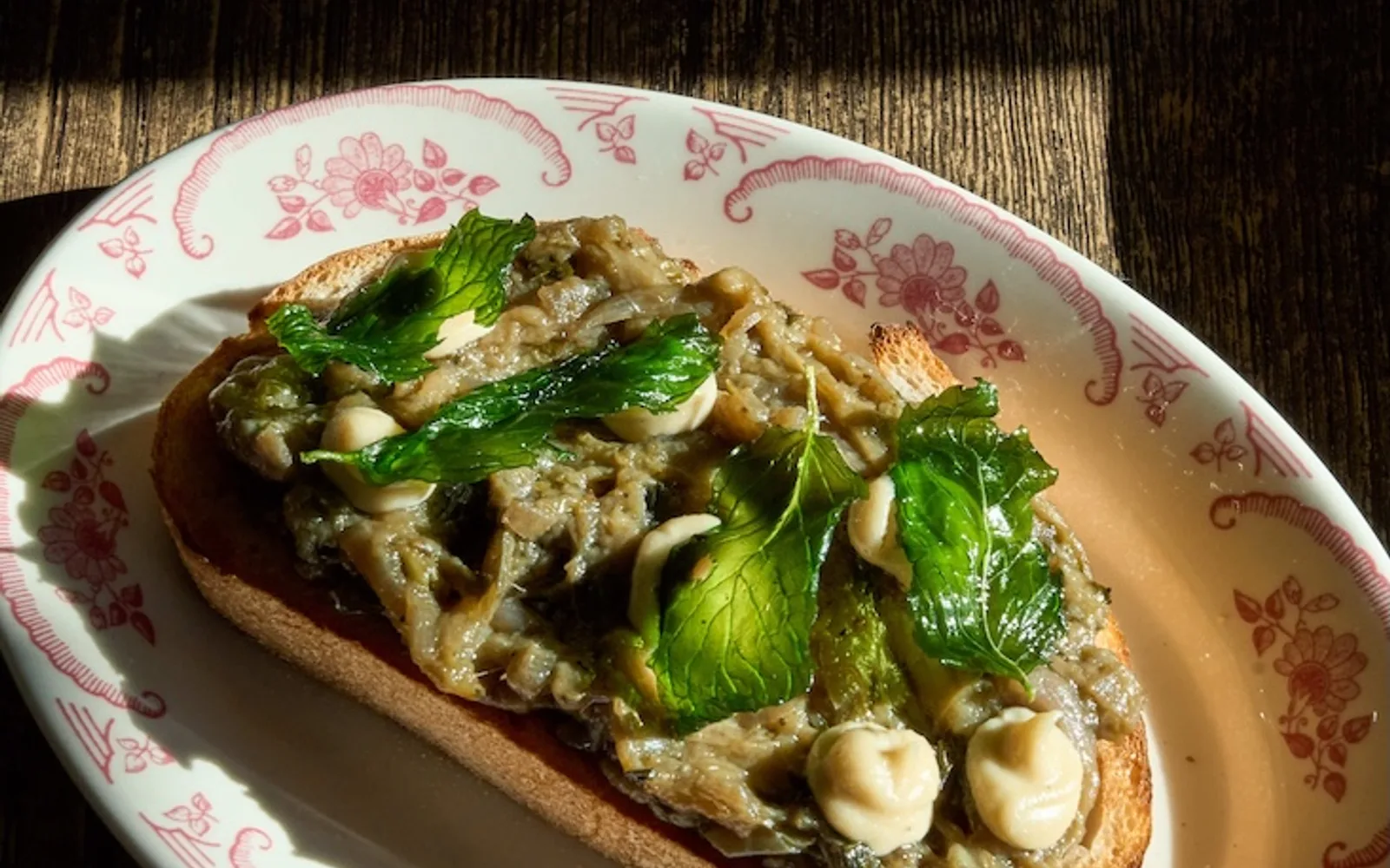 Vegetable-topped toast with basil on Civico 1845 floral tableware